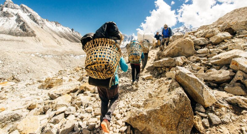Träger in Nepal mit Gepäck